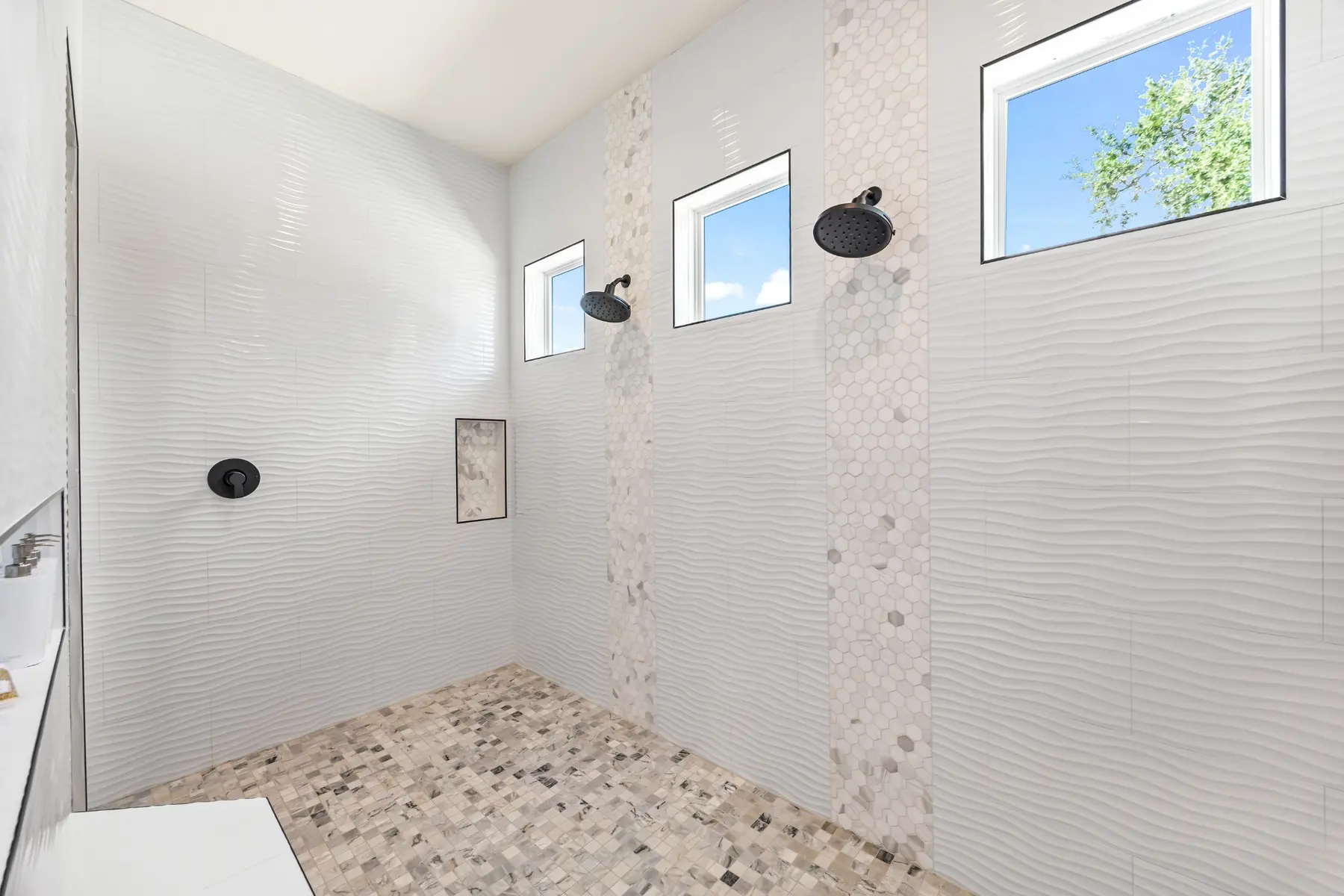 Oversized Brook Canyon walk-in shower with dual showerheads and mosaic tile