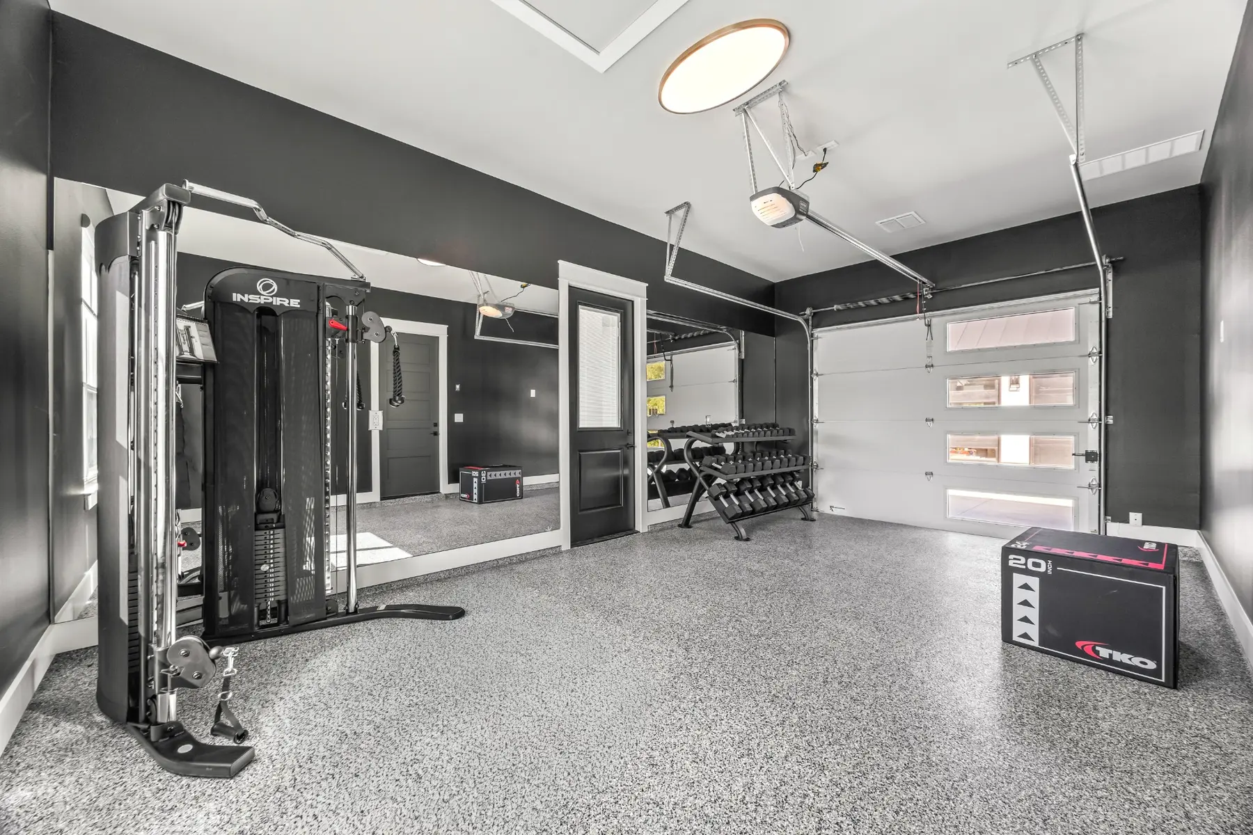 Finished Brook Canyon home gym with mirrored wall and durable flooring