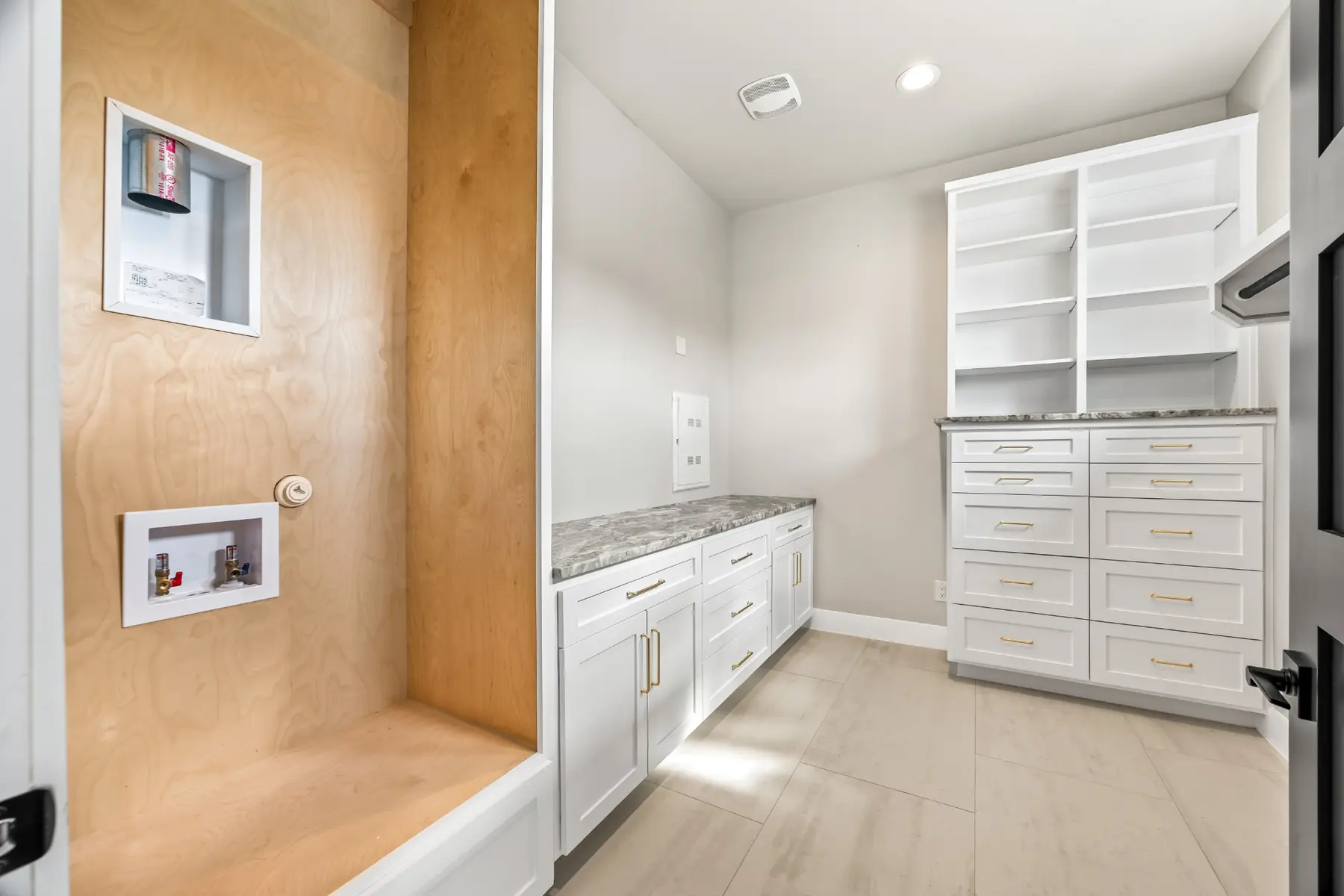 Brook Canyon laundry room with extensive custom cabinetry and folding counters