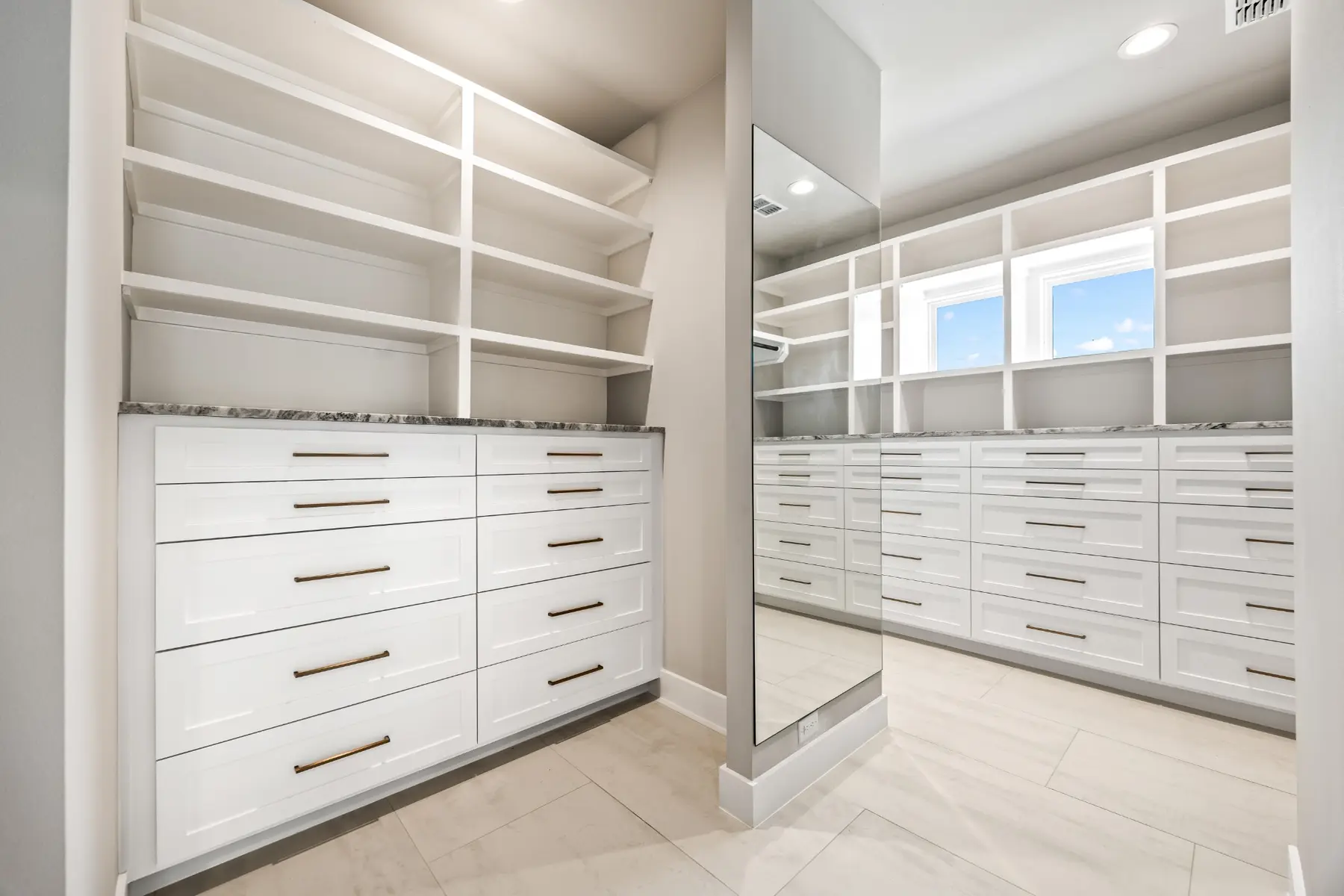 Custom Brook Canyon walk-in closet with built-in drawers, shelving, and full-length mirror